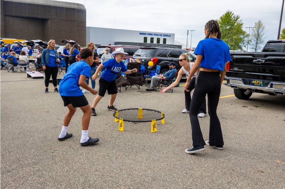 Students play spike ball game during tailgate.